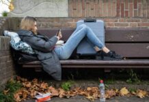 Aanpak dakloosheid ‘Wonen eerst’ in een wooncrisis jonge vrouw met koffer op bankje buiten